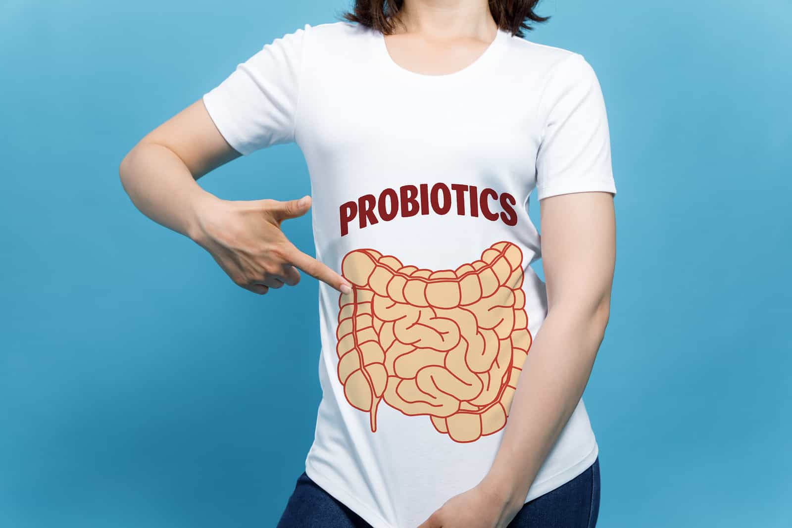 best probiotic for IBS: Woman pointing to the illustration of an intestine on her shirt