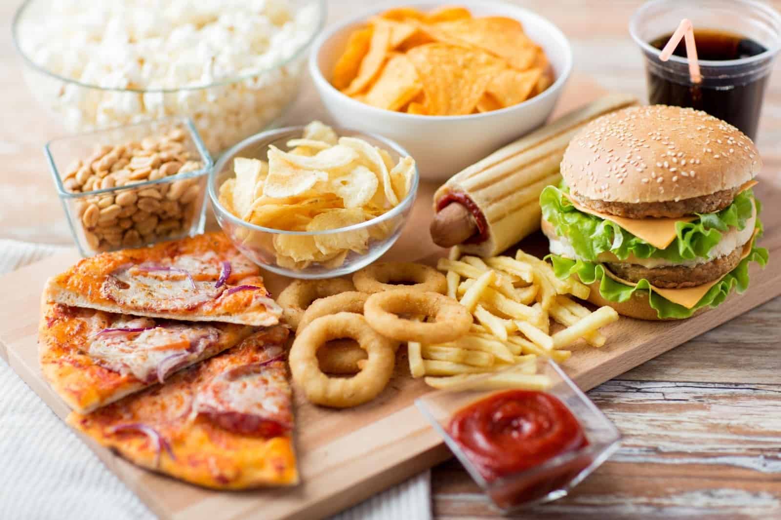 IBS foods to avoid: Variety of snacks on a wooden table