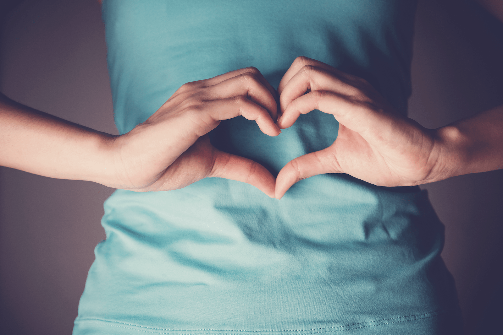 integrative health: person forming a heart with their hands