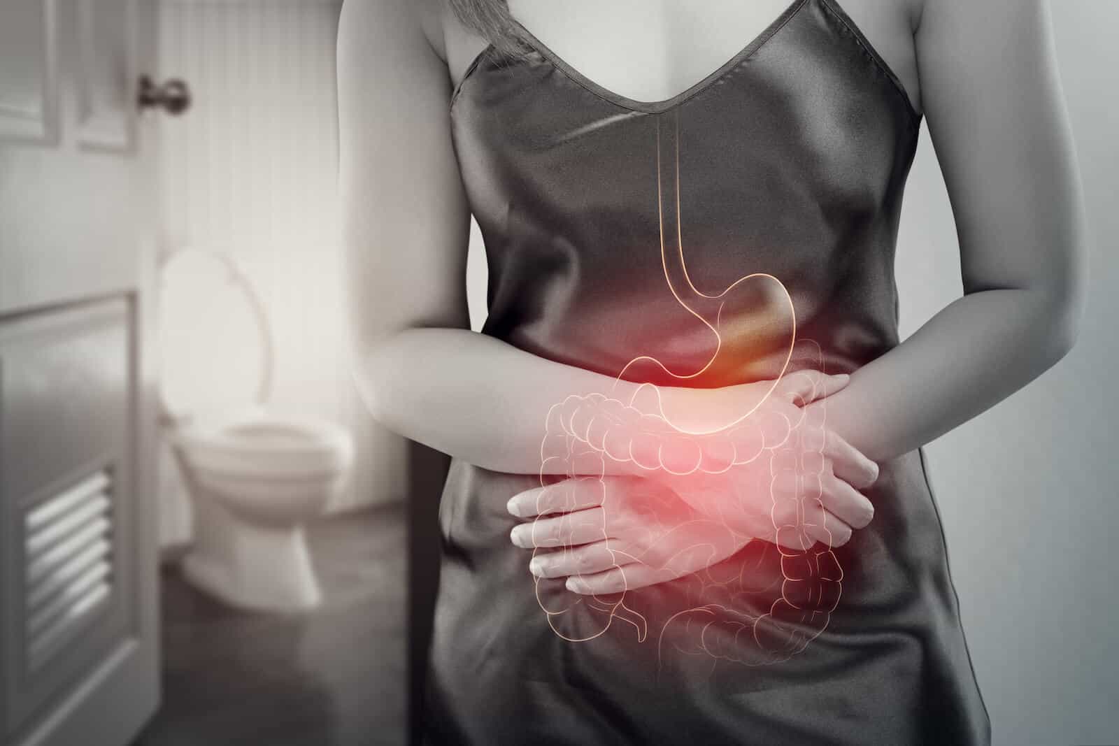 Do probiotics help with constipation: woman holding her stomach in pain
