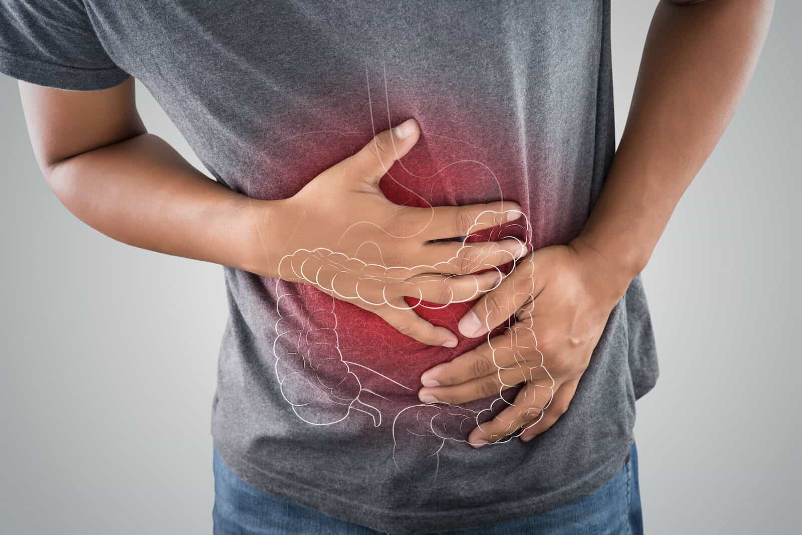 Colonic: large intestine illustration over a photo of a person with stomachache